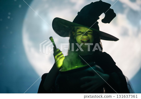 Girl dressed in witch costumes for Halloween Girl dressed in witch costumes for Halloween 131637361