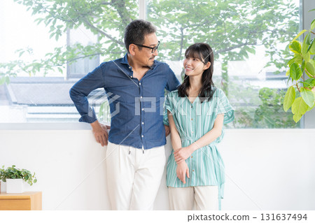 A middle-aged couple relaxing in the living room 131637494