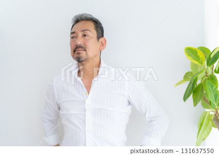 Middle-aged man doing skin care in the living room Middle-aged man doing skin care in the living room 131637550