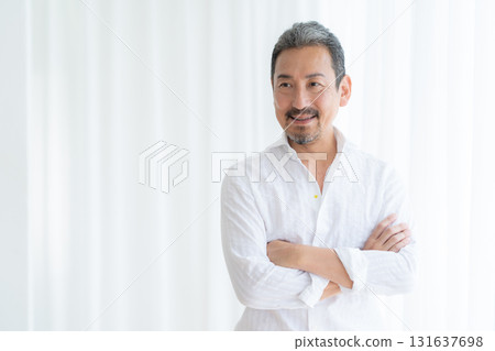 Middle-aged man doing skin care in the living room Middle-aged man doing skin care in the living room 131637698
