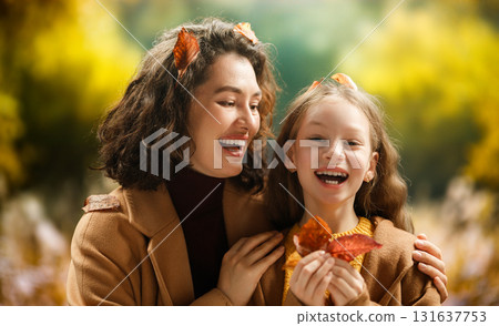 Woman and child holding a roast turkey together 131637753