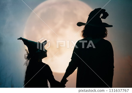 Woman and child holding a roast turkey together Woman and child holding a roast turkey together 131637767