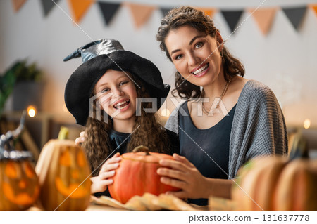Woman and child holding a roast turkey together Woman and child holding a roast turkey together 131637778