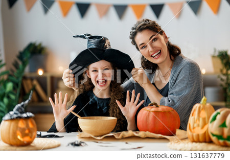 Woman and child holding a roast turkey together Woman and child holding a roast turkey together 131637779