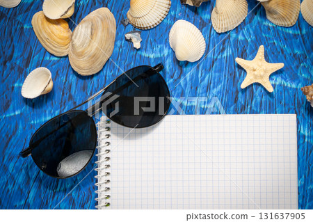 flat lay on blue background blank notebook copy space. summer plans concept flat lay on blue background blank notebook copy space. summer plans concept 131637905