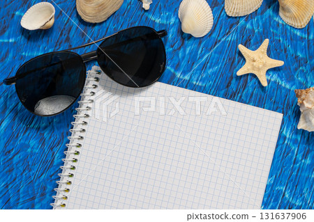 flat lay on blue background blank notebook copy space. summer plans concept flat lay on blue background blank notebook copy space. summer plans concept 131637906