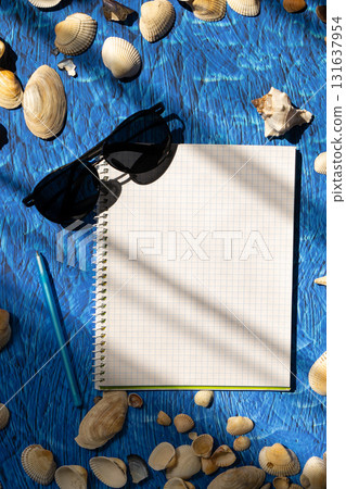 flat lay on blue background blank notebook copy space. summer plans concept 131637954