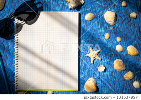 flat lay on blue background blank notebook copy space. summer plans concept flat lay on blue background blank notebook copy space. summer plans concept 131637957