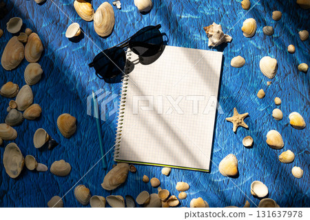 flat lay on blue background blank notebook copy space. summer plans concept flat lay on blue background blank notebook copy space. summer plans concept 131637978