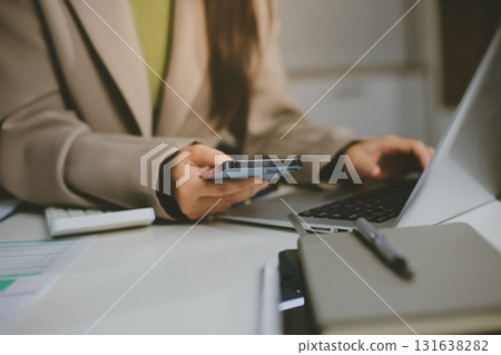 Portrait of young Hispanic professional business woman standing in office. Happy female company executive, smiling businesswoman entrepreneur corporate leader manager looking at camera using tablet Portrait of young Hispanic professional business woman standing in office. Happy female company executive, smiling businesswoman entrepreneur corporate leader manager looking at camera using tablet 131638282