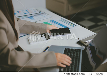Portrait of young Hispanic professional business woman standing in office. Happy female company executive, smiling businesswoman entrepreneur corporate leader manager looking at camera using tablet Portrait of young Hispanic professional business woman standing in office. Happy female company executive, smiling businesswoman entrepreneur corporate leader manager looking at camera using tablet 131638283