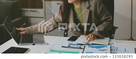 Portrait of young Hispanic professional business woman standing in office. Happy female company executive, smiling businesswoman entrepreneur corporate leader manager looking at camera using tablet Portrait of young Hispanic professional business woman standing in office. Happy female company executive, smiling businesswoman entrepreneur corporate leader manager looking at camera using tablet 131638293