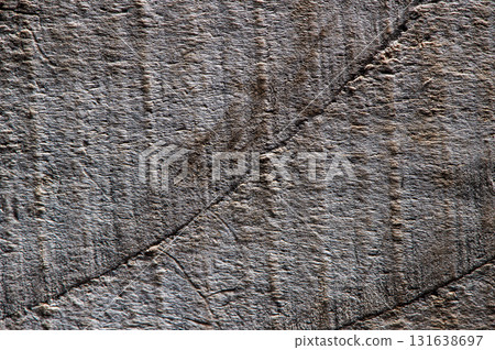 The dark texture of the wood resembles a frozen wave or a wrinkle of nature The dark texture of the wood resembles a frozen wave or a wrinkle of nature 131638697