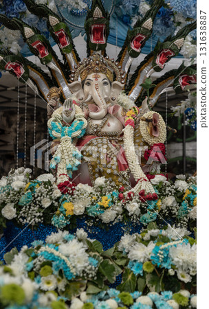 The statue of the Hindu deity Ganesha or Ganesh. He is easily recognizable by his elephant head, large belly, and four arms. 131638887