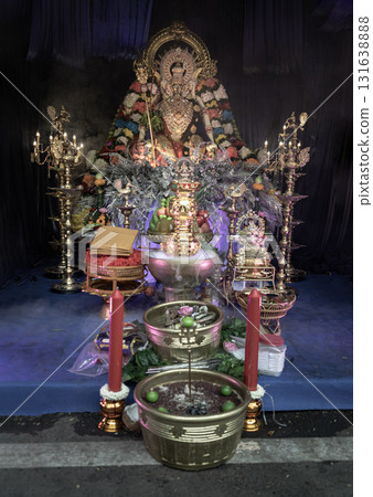 The statue depicts a goddess with multiple arms of the Hindu goddess Durga, specifically in the form of Mahishasuramardini. The display is a form of worship. The statue depicts a goddess with multiple arms of the Hindu goddess Durga, specifically in the form of Mahishasuramardini. The display is a form of worship. 131638888