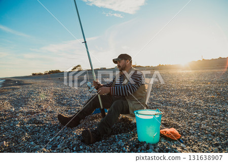 Fisherman Having Fun On The Shore At Sunrise Fisherman Having Fun On The Shore At Sunrise 131638907