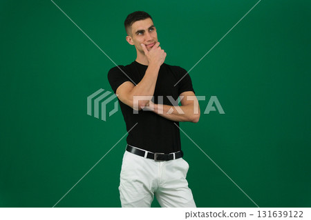 Set of videos featuring handsome European man with dark hair and expressive eyebrows wearing black t shirt and white pants showing different emotions and gestures on green chroma key background Set of videos featuring handsome European man with dark hair and expressive eyebrows wearing black t shirt and white pants showing different emotions and gestures on green chroma key background 131639122