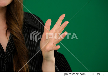 Set of videos featuring female hands of young European woman making different gestures on green chroma key background showing folded hands open palms and clenched fingers with copy space Set of videos featuring female hands of young European woman making different gestures on green chroma key background showing folded hands open palms and clenched fingers with copy space 131639130