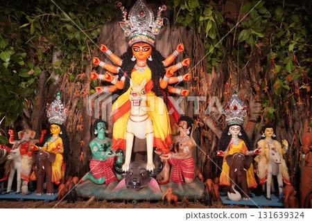 Traditional Durga Puja Idol and Family Under Banyan Tree Roots Pandal 131639324