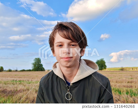 Happy teenage boy in nature in autumn. Portrait. Boy enjoying nature and going for a walk in the fresh air. Happy teenage boy in nature in autumn. Portrait. Boy enjoying nature and going for a walk in the fresh air. 131640268