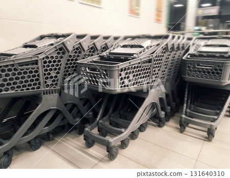 Stacked Shopping Carts Retail and Consumerism Concept. Stacked Shopping Carts Retail and Consumerism Concept. 131640310