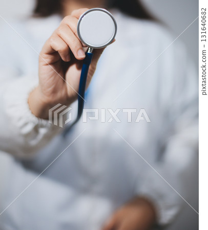 A young male doctor holding an stethoscope A young male doctor holding an stethoscope 131640682