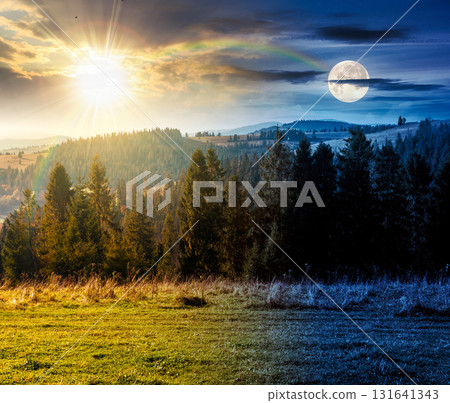 rural area in mountains on autumn equinox. day and night time change concept. wonderful highland with sun and moon at twilight observed from the hillside. meadows on rolling hills near spruce forest 131641343