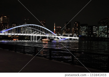 Tsukiji Bridge shining on the Sumida River with Tokyo Tower in the background at night. September 972. Night view: Tokyo Tower and Tsukiji Bridge. Tsukiji Bridge shining on the Sumida River with Tokyo Tower in the background at night. September 972. Night view: Tokyo Tower and Tsukiji Bridge. 131641433