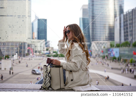 Woman with sunglasses holding notebook Woman with sunglasses holding notebook 131641552