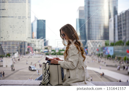 Woman reading and writing outdoors 131641557