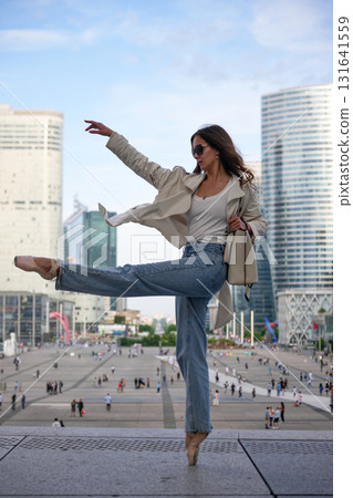 Young woman posing like ballerina outdoors 131641559