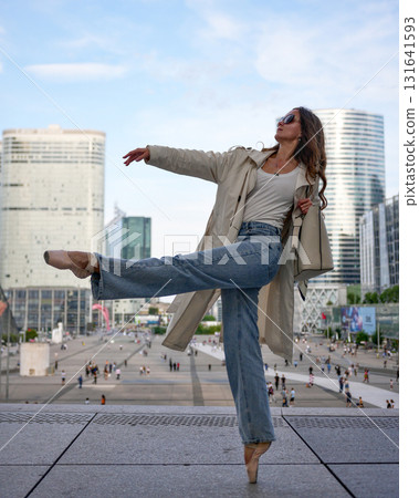 Graceful young woman dancing ballet outdoors in urban cityscape 131641593