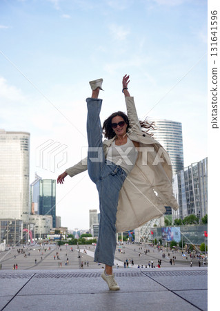 Ballet dancer high kick urban skyline 131641596