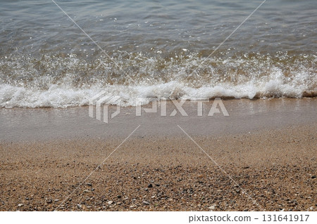 Ocean scenery with waves crashing on the shore of a sandy beach 131641917