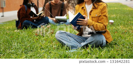Happy students walking together on university campus, chatting and laughing outdoors after classes Happy students walking together on university campus, chatting and laughing outdoors after classes 131642281