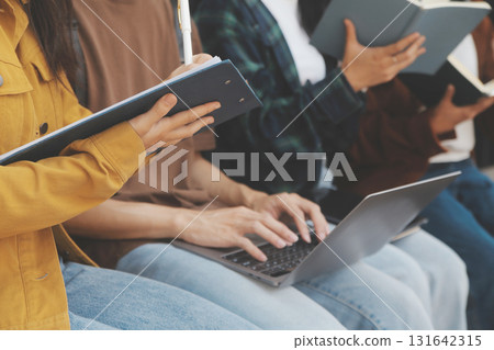 Happy students walking together on university campus, chatting and laughing outdoors after classes Happy students walking together on university campus, chatting and laughing outdoors after classes 131642315