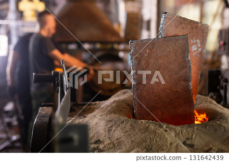Ferrous metal billet is melted in an induction furnace closeup Ferrous metal billet is melted in an induction furnace closeup 131642439