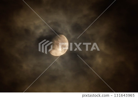 The moon hidden behind thin clouds 131643965