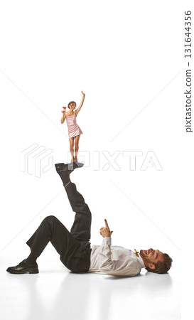 Bright poster. Tiny woman standing on man raised leg with cocktail in hand 131644356