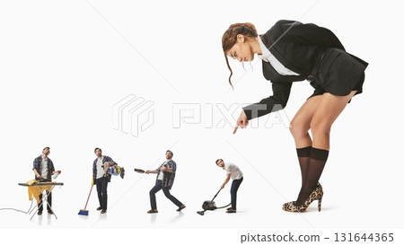 Graphic composition. Powerful woman pointing at tiny men performing household chores 131644365