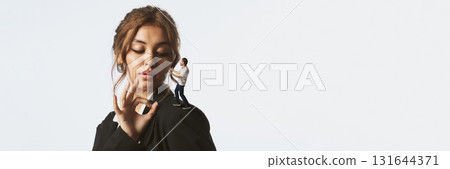 Collage of confident woman looking at tiny man standing on her shoulder in dialogue pose. Banner 131644371