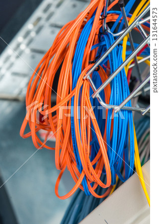 Detail of server room with bunch of fiber optic cables at the ba Detail of server room with bunch of fiber optic cables at the ba 131644573