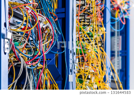 Server rack with fiber optic cables attached to front panel swit 131644583