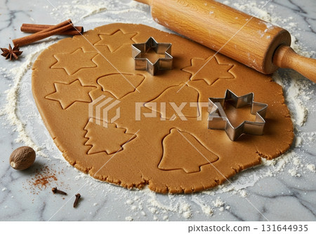 Christmas Baking Scene with Gingerbread Cookie Dough and Festive Cutters on a Marble Surface 131644935