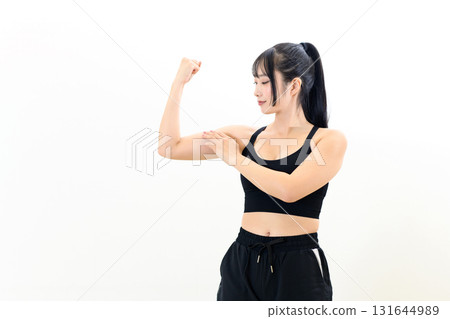 Cool woman working out, building bicep, muscle training girl, sports bra, white background 131644989