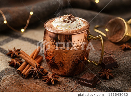 Cozy Winter Hot Chocolate in a Polished Copper Mug with Whipped Cream and Spices 131645080