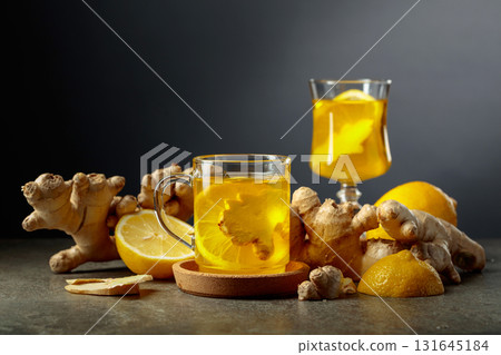 Ginger tea with lemon on a black background. 131645184