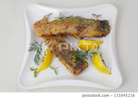 Fried fish lemons breaded fish with dipping sauce and lemon 131645216