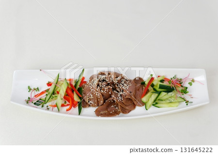 Spicy Grilled beef with Cucumber Salad,grilled meat with onion and sliced cucumber in chilli lime sauce.(Yum Neua Yang) 131645222