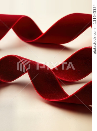 Luxurious Red Velvet Ribbon Flowing Elegantly for a Festive Christmas Celebration Background 131645524